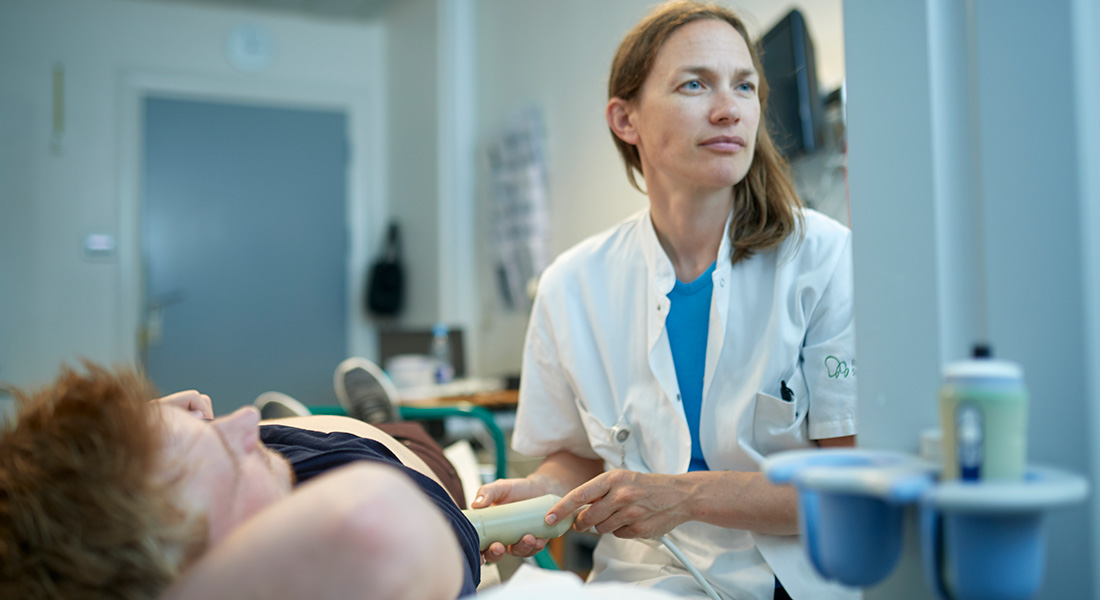 A doctor performing an ultrasound scan. A doctor performing an ultrasound scan.
