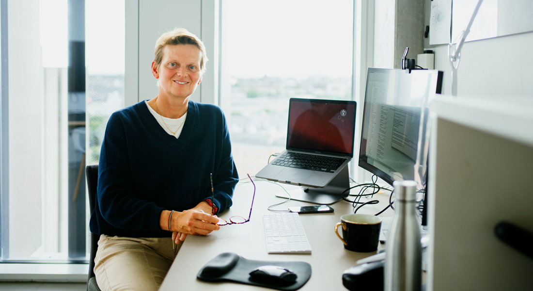 Photo of researcher Ruth Loos sitting at her desk in her office
